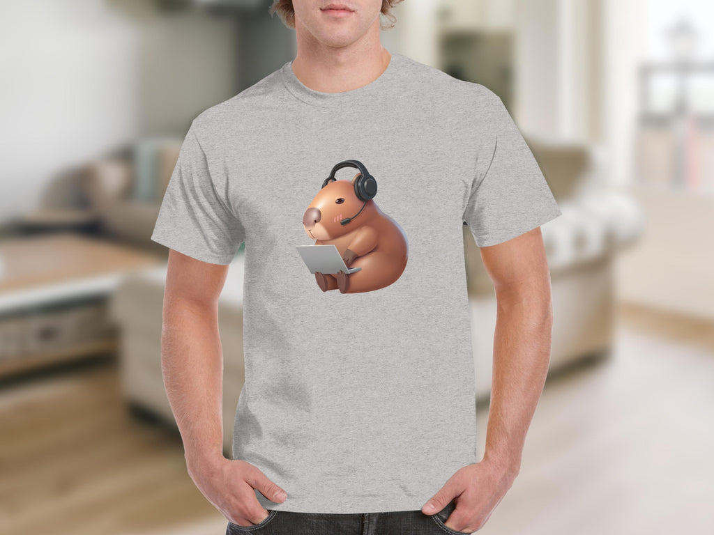 Brown capybara wearing headset and holding laptop on light gray t-shirt.