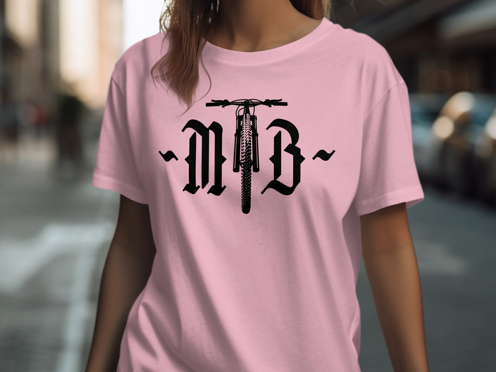 Pink t-shirt with black gothic "MTB" text and a bicycle wheel graphic.
