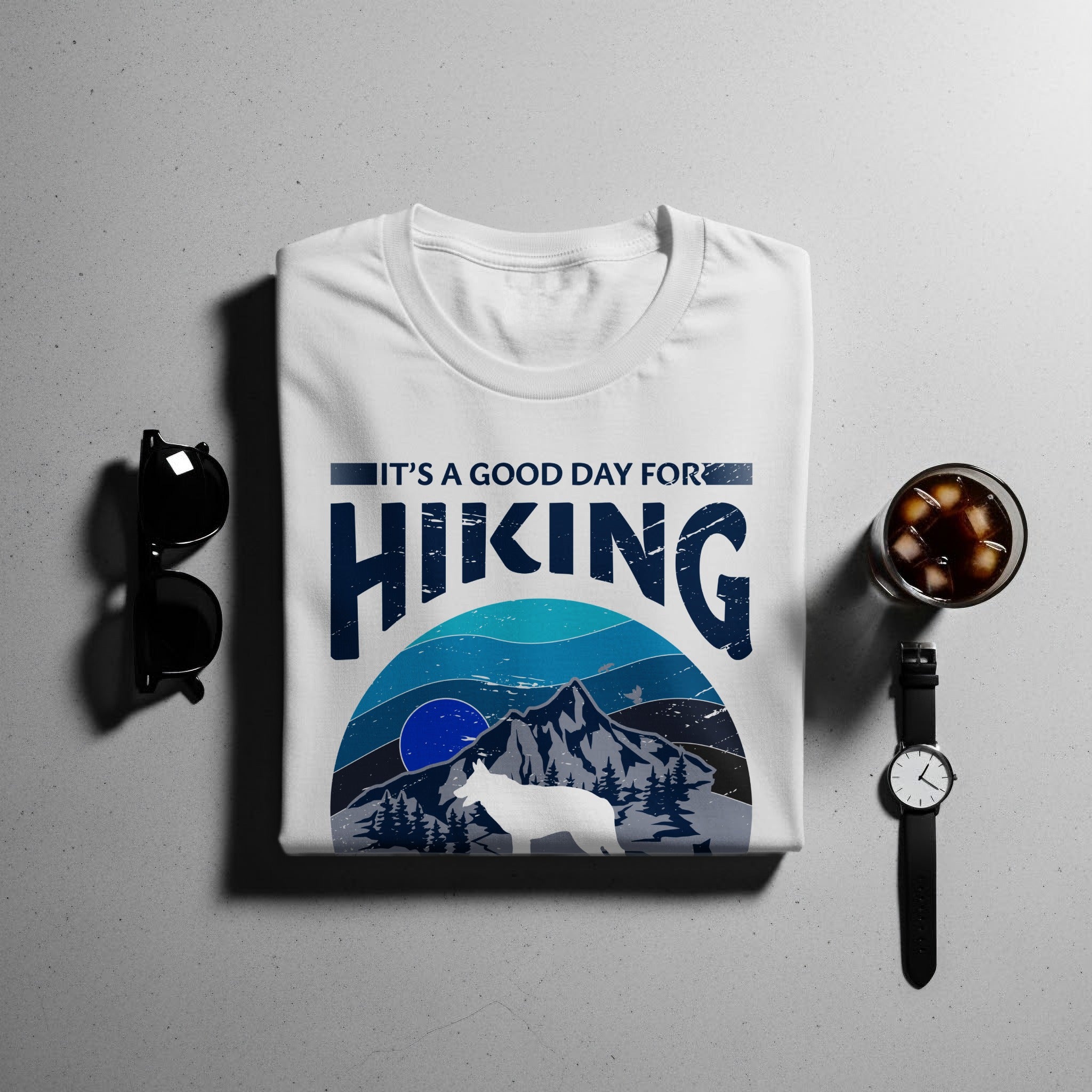 White t-shirt with "IT'S A GOOD DAY FOR HIKING" graphic and mountain scene.