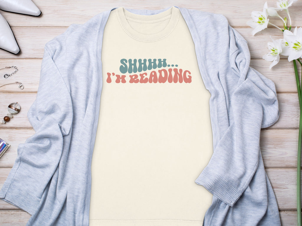Light cream t-shirt with text "SHHHH... I'M READING"