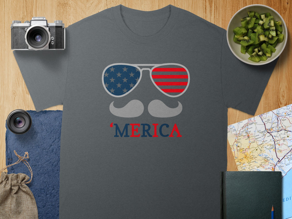 Dark gray t-shirt with "MERIC`A" and American flag sunglasses graphic.