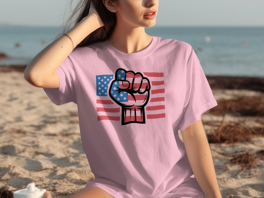 Pink t-shirt with American flag fist graphic on beach background