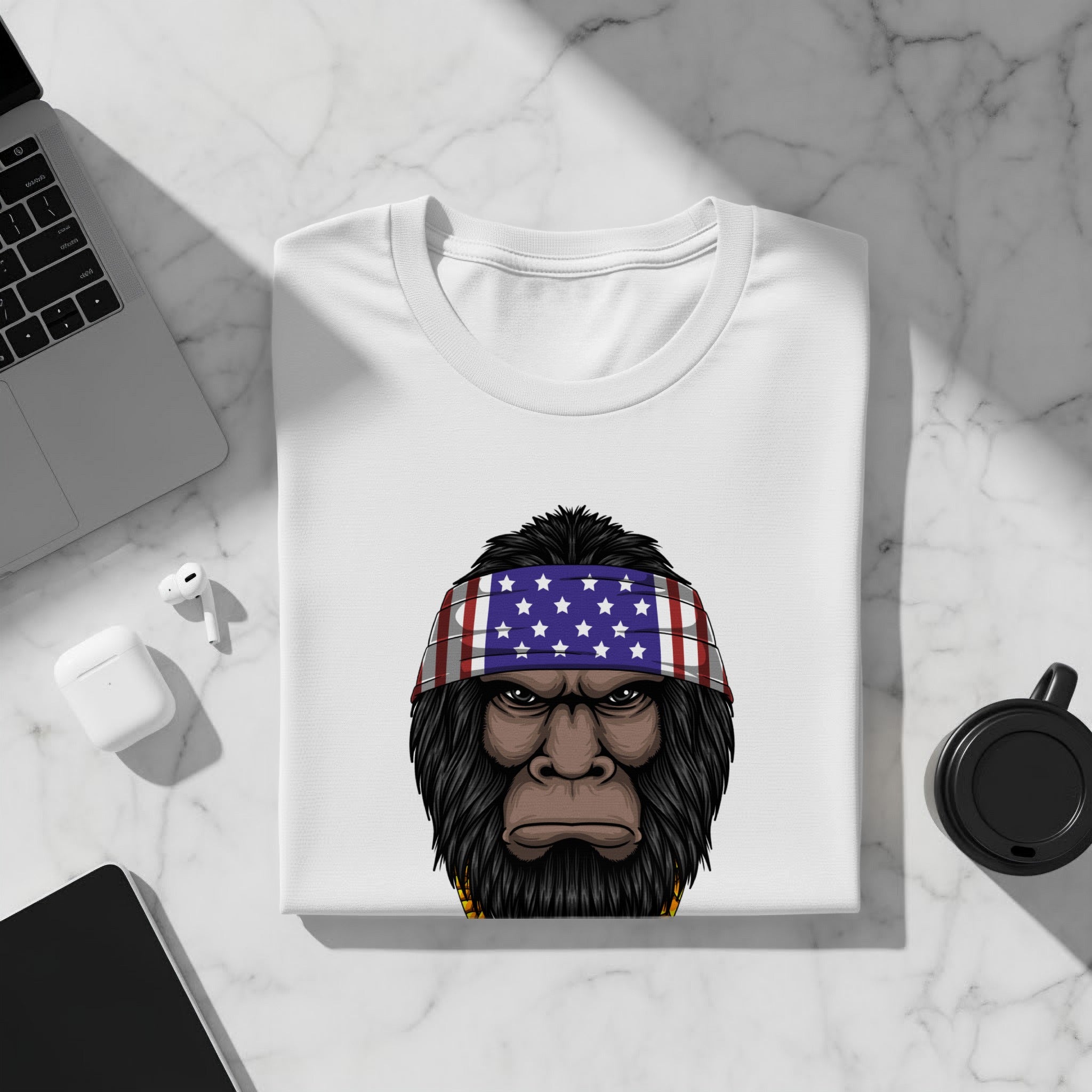 White t-shirt with a Bigfoot graphic wearing an American flag bandana.