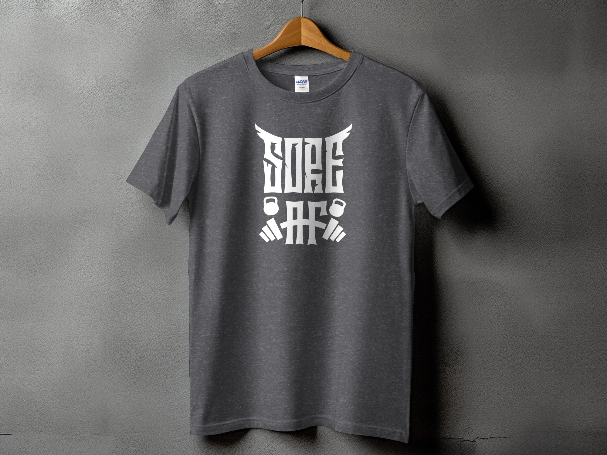 Grey t-shirt with white text and graphics featuring kettlebells and barbell elements.