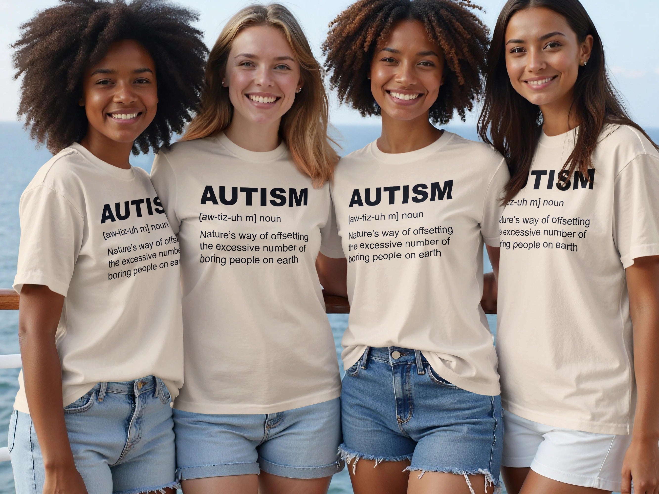 Four women wear light-colored t-shirts with "Autism" and its definition printed on them.