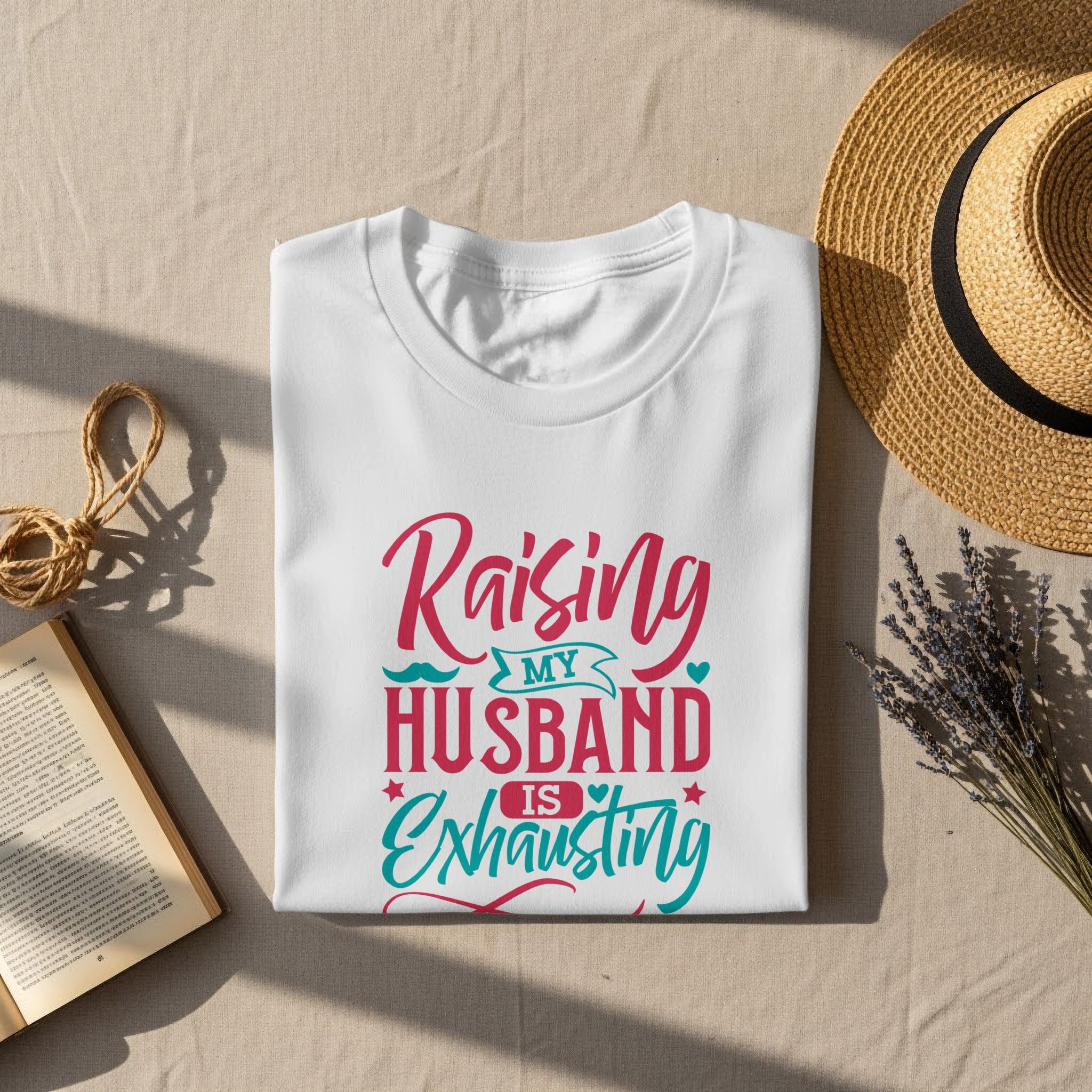White t-shirt with "Raising My Husband Is Exhausting" text design.