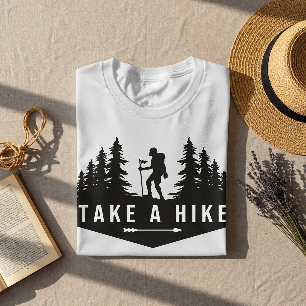 White t-shirt with "TAKE A HIKE" text and hiker silhouette among trees.