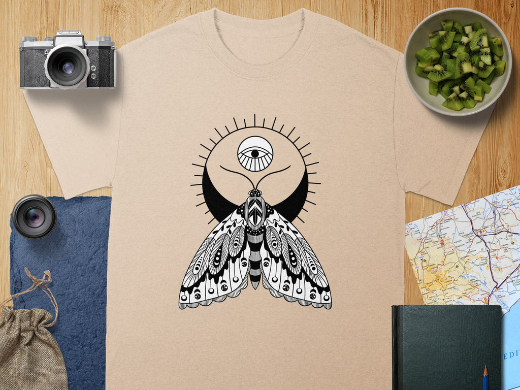 T-shirt with black and white moth, crescent moon, and eye design.