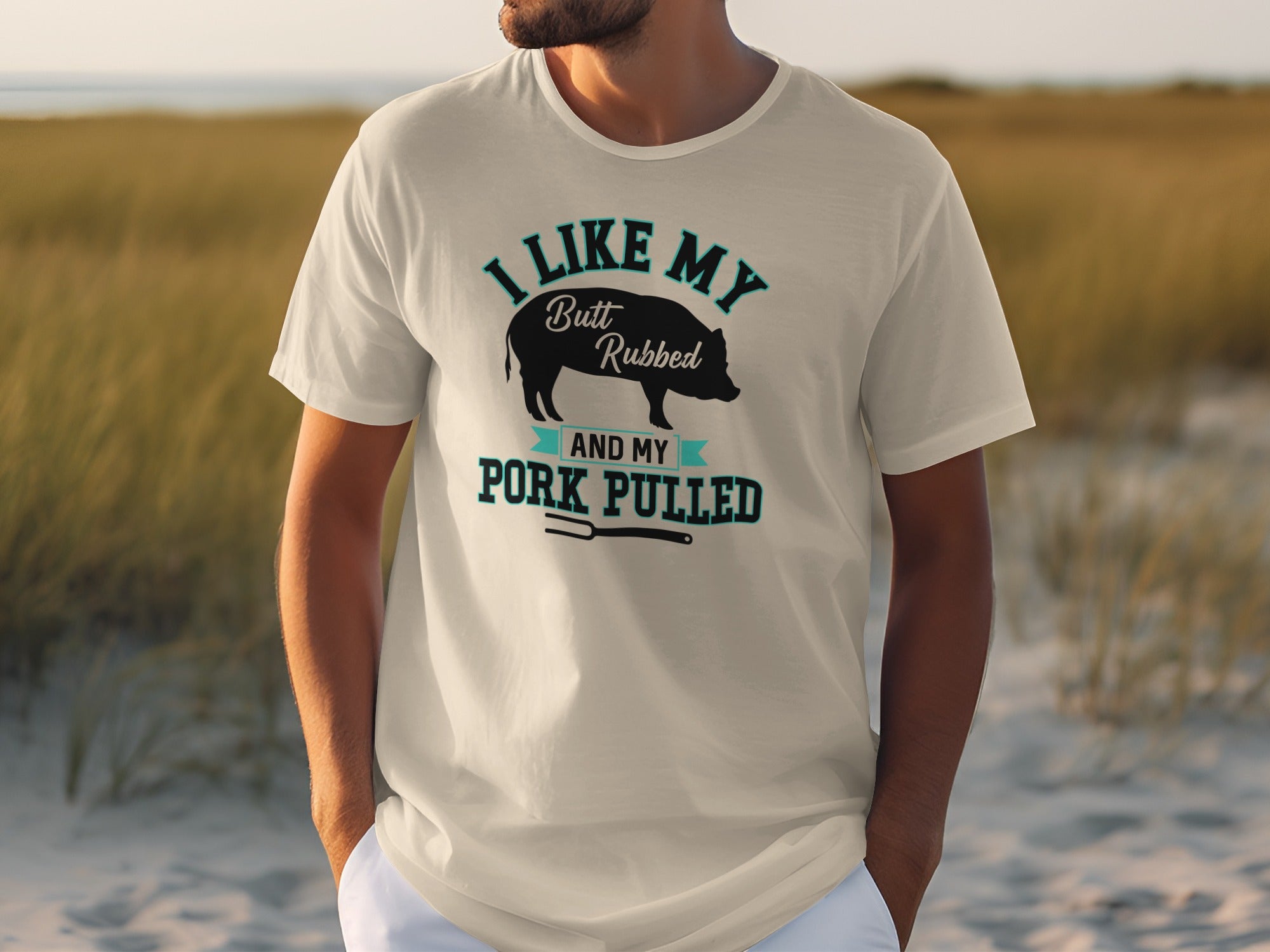 Cream t-shirt with graphic of pig and text "I LIKE MY Butt Rubbed AND MY Pork PULLED".