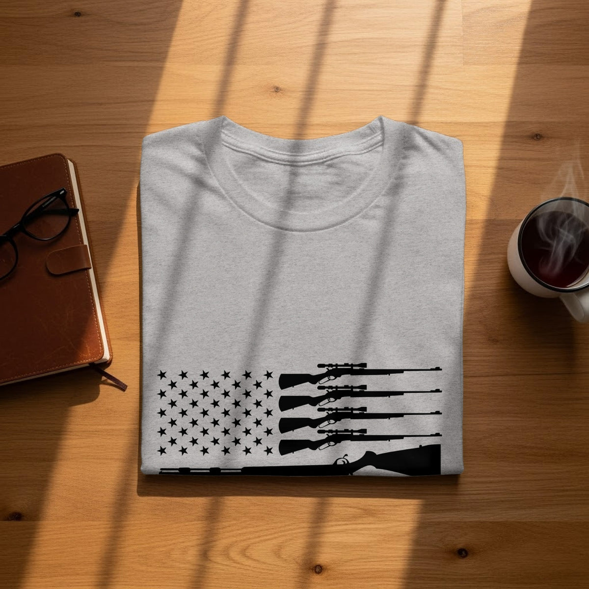 Light gray t-shirt with a black rifle and stars design resembling the US flag.