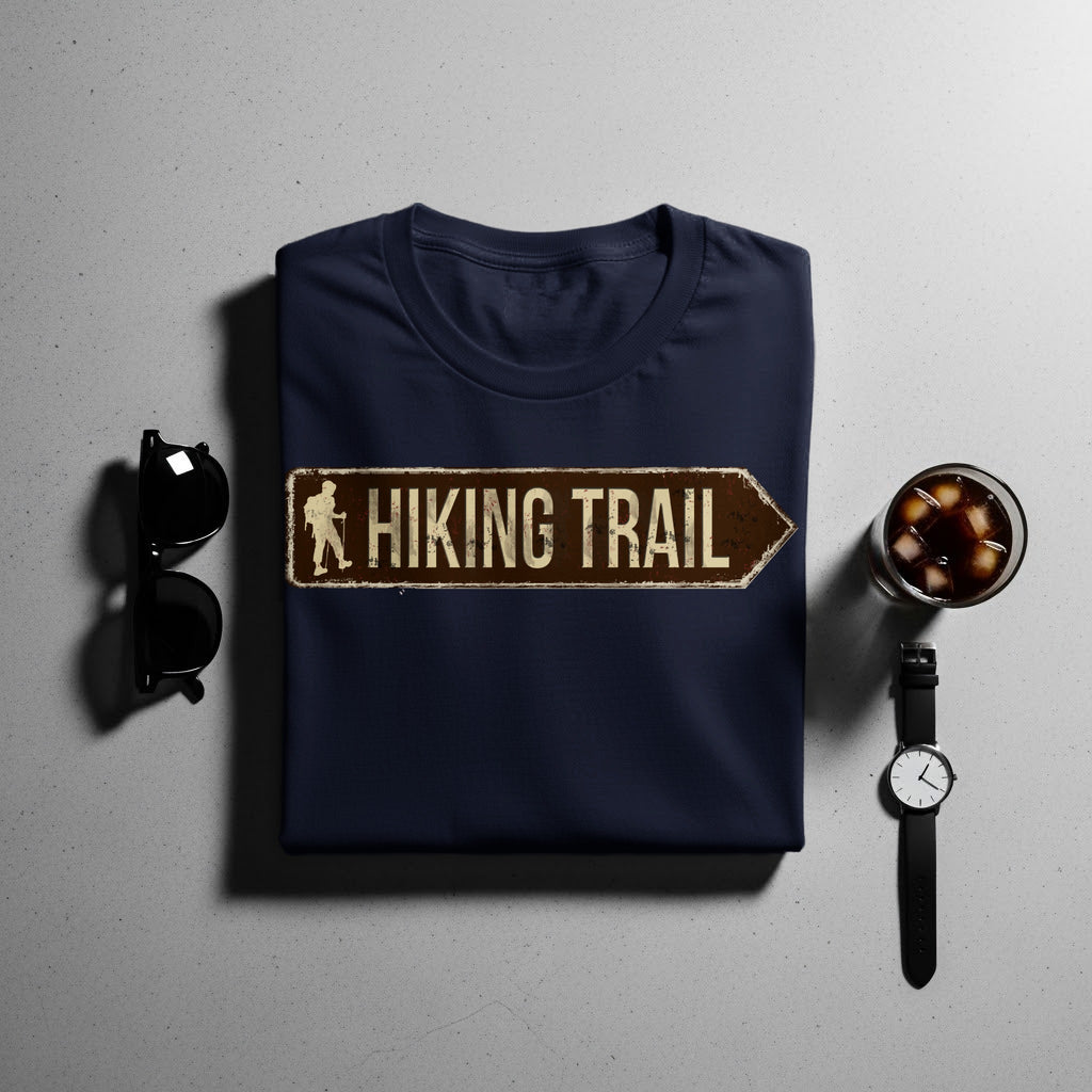 Navy t-shirt with brown hiking trail sign graphic and accessories.