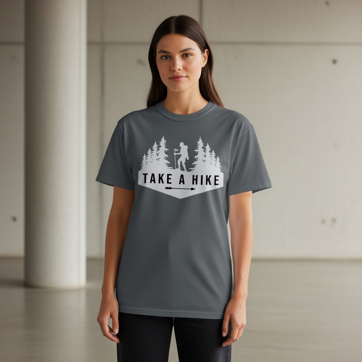 Dark grey t-shirt with a white graphic of trees, a hiker, and text "TAKE A HIKE".