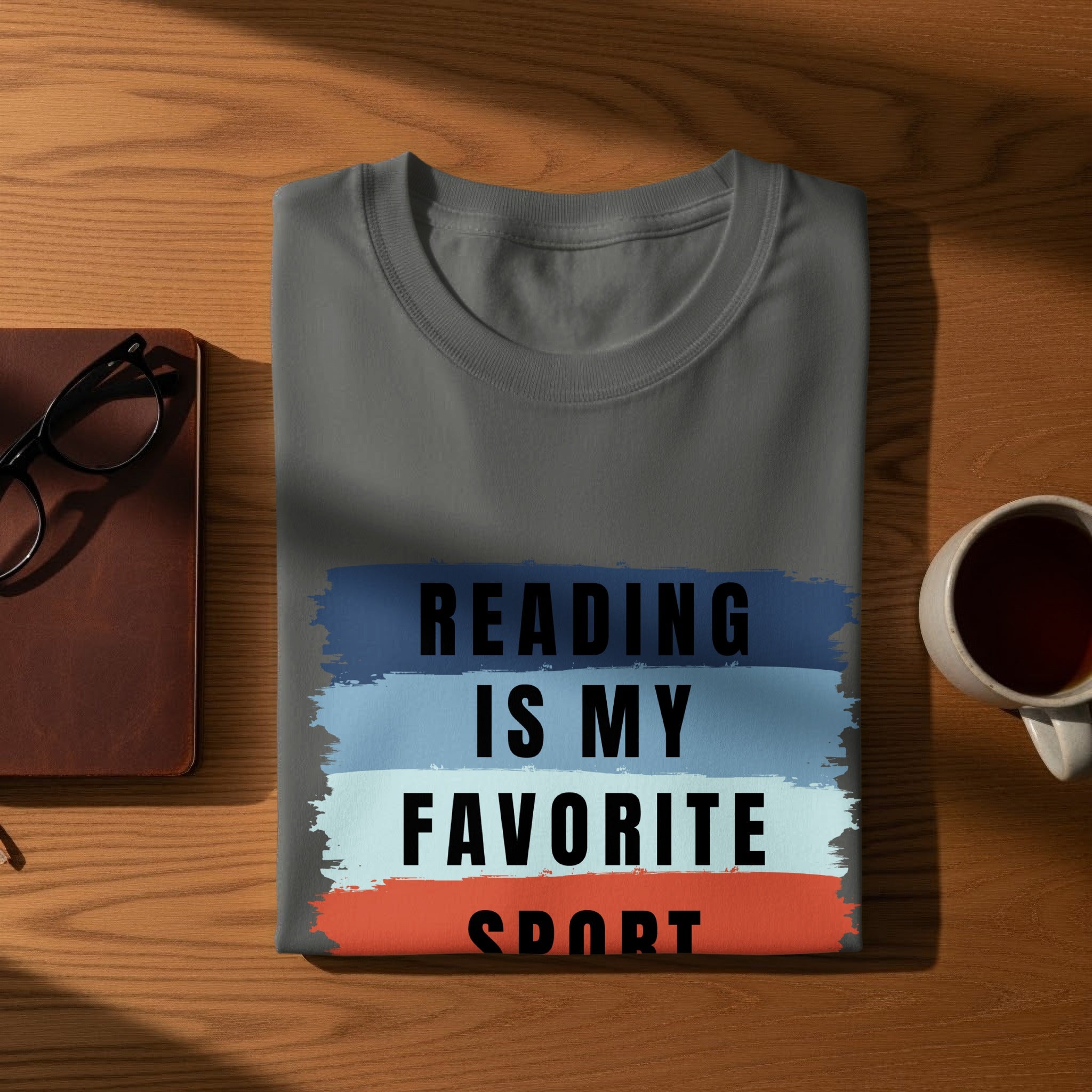 Gray t-shirt with "Reading is my favorite sport" text on brush strokes.
