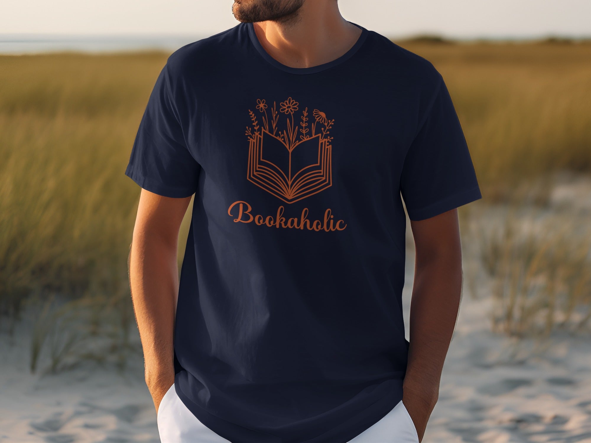 Navy t-shirt with an orange open book and floral design and "Bookaholic" text.