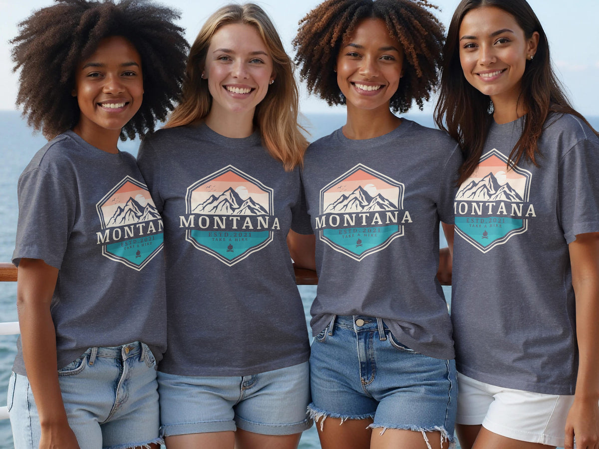 Four women wear matching grey t-shirts with "Montana" mountain graphic and text.