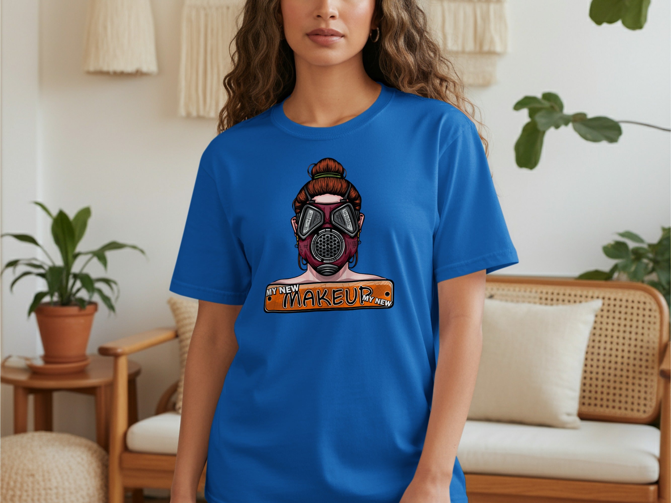 Blue t-shirt featuring a graphic of a person wearing a gas mask and the text "MY NEW MAKEUP".