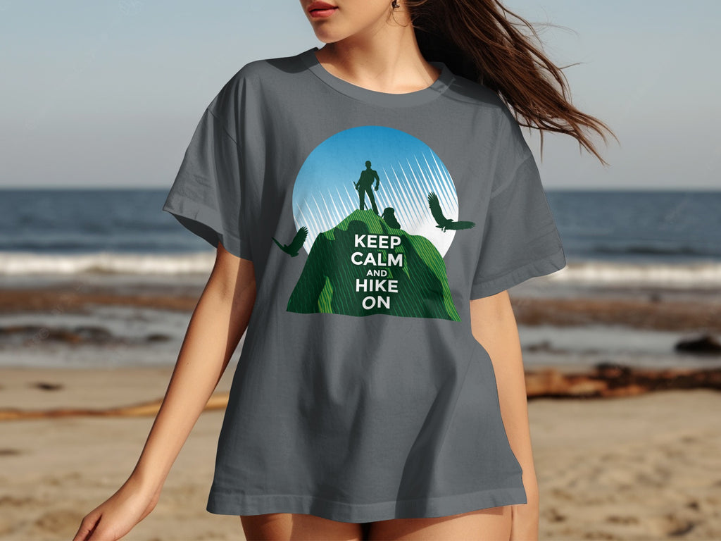 Graphic t-shirt with text "KEEP CALM AND HIKE ON" featuring mountain climber and birds.