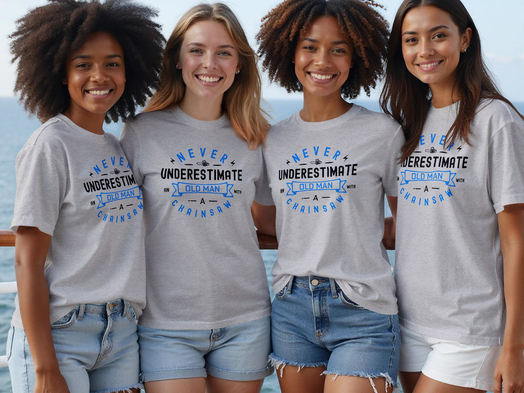 Four women in gray t-shirts with "Never Underestimate An Old Man With A Chainsaw" text.