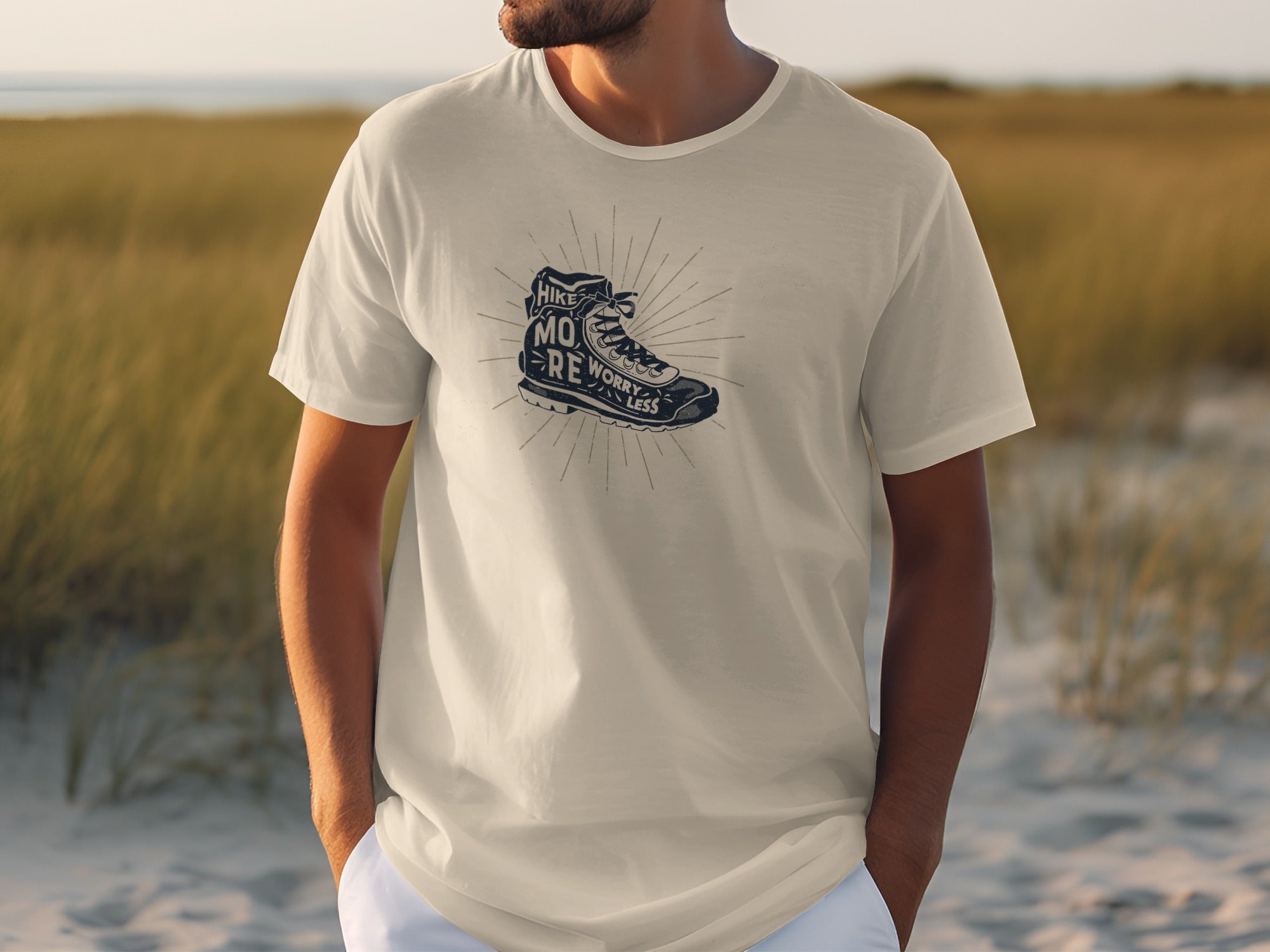 White t-shirt with dark graphic of a hiking boot and text "Hike More Worry Less".