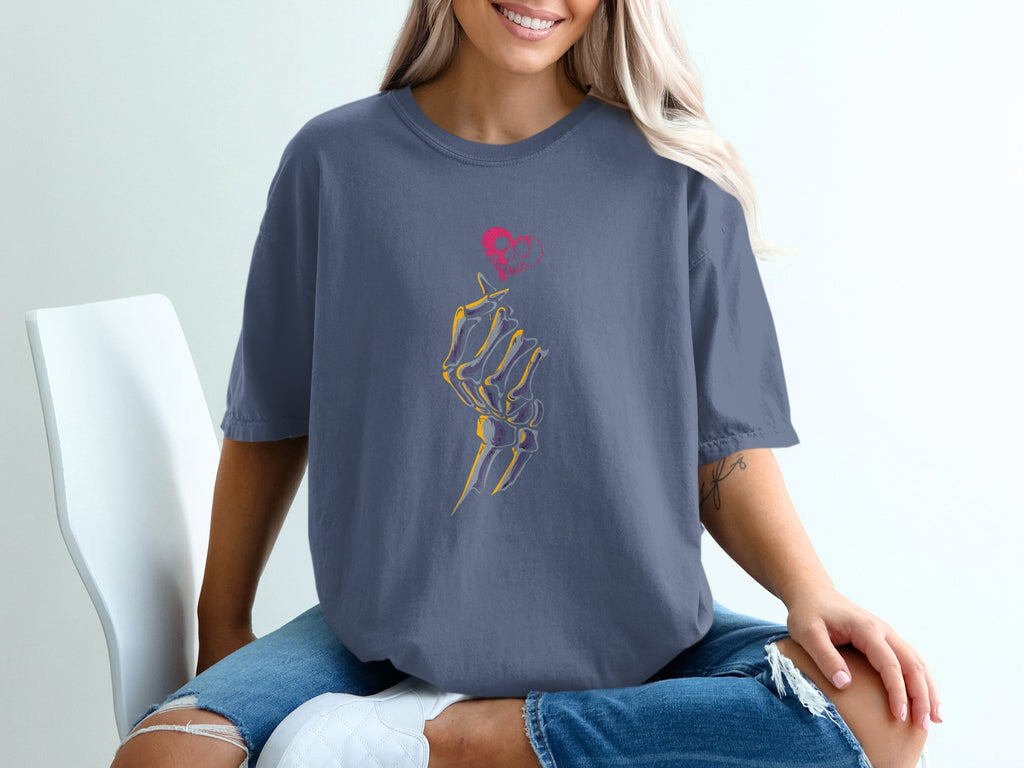 Blue t-shirt with skeleton hand making finger heart gesture graphic.