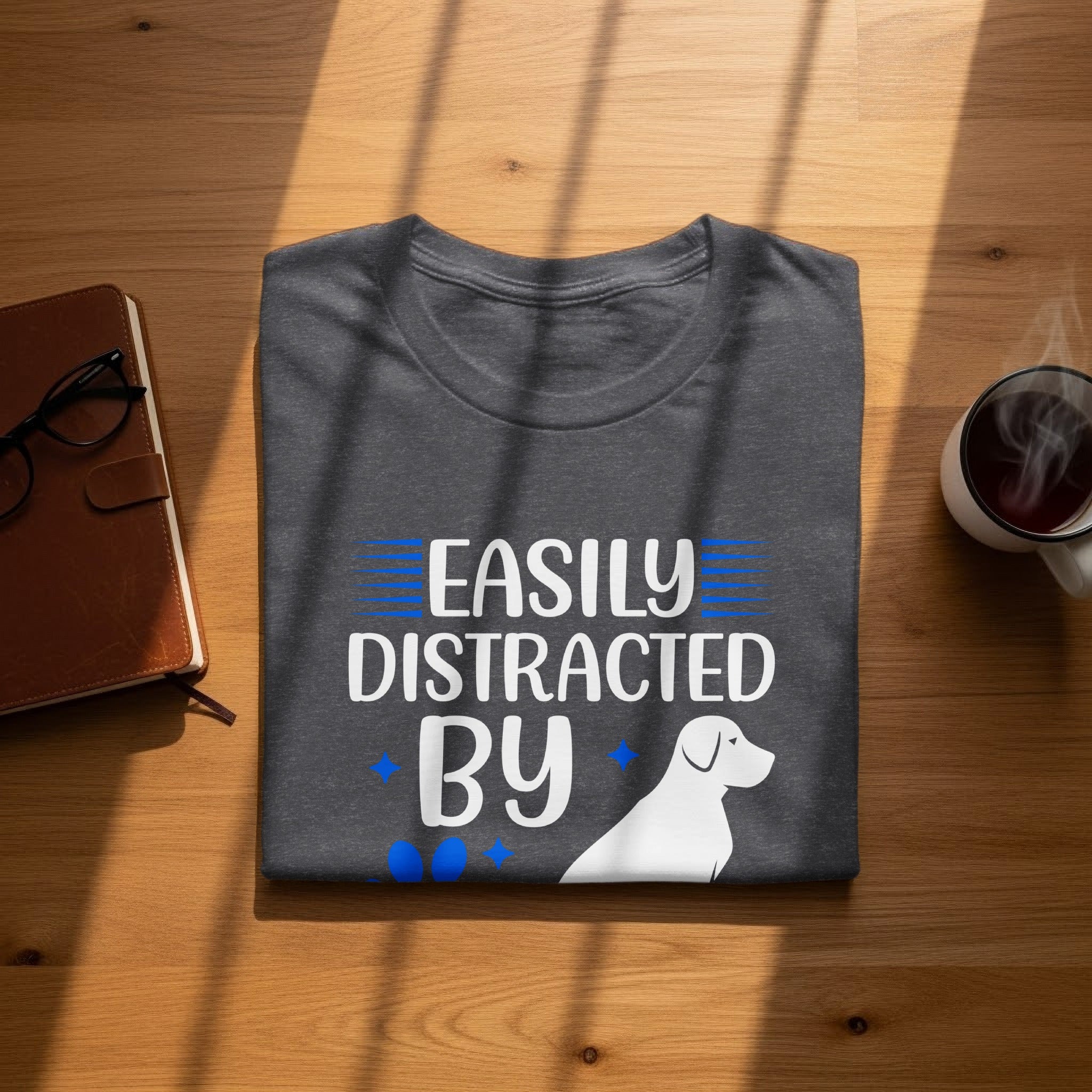 Dark gray t-shirt with "Easily Distracted By Dogs" in white text and a white dog silhouette.