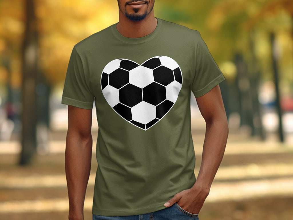 T-shirt with a heart-shaped soccer ball graphic on a blurred park background.