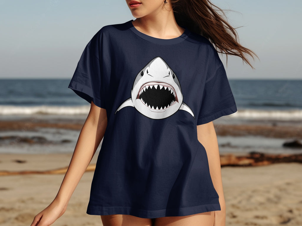 Navy t-shirt with a cartoon shark graphic on the front, beach background.