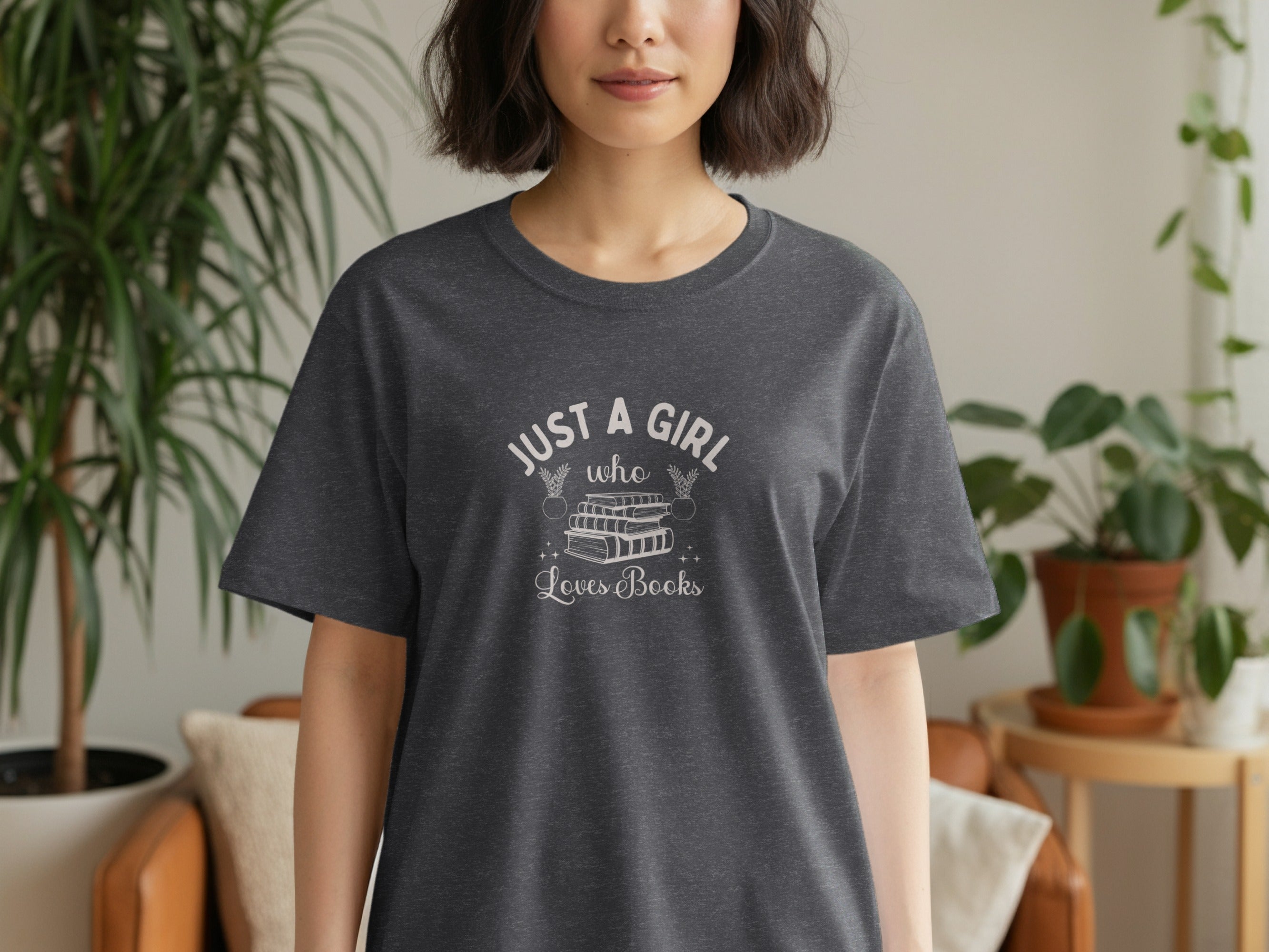 Dark gray t-shirt with "JUST A GIRL who Loves Books" text and stack of books graphic.