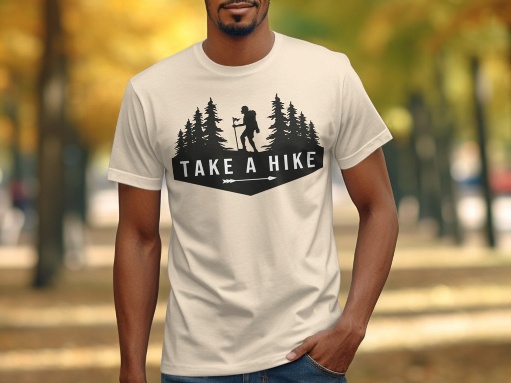 T-shirt with black graphic of hiker, trees, and text "TAKE A HIKE."