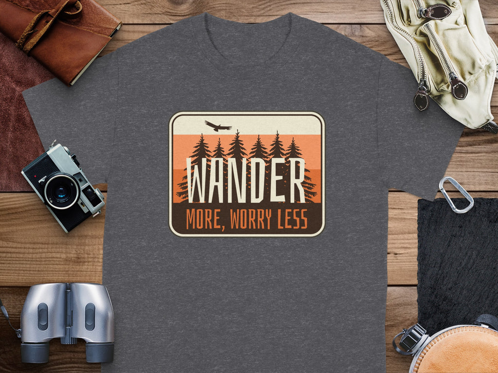 Dark grey t-shirt with "WANDER MORE, WORRY LESS" graphic featuring pine trees and an eagle.