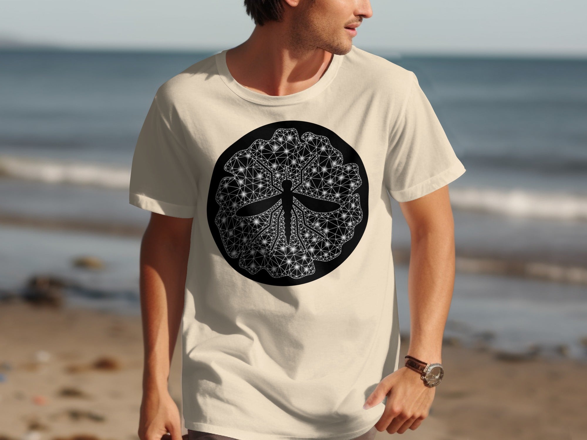 Cream t-shirt with circular black and white geometric dragonfly design.