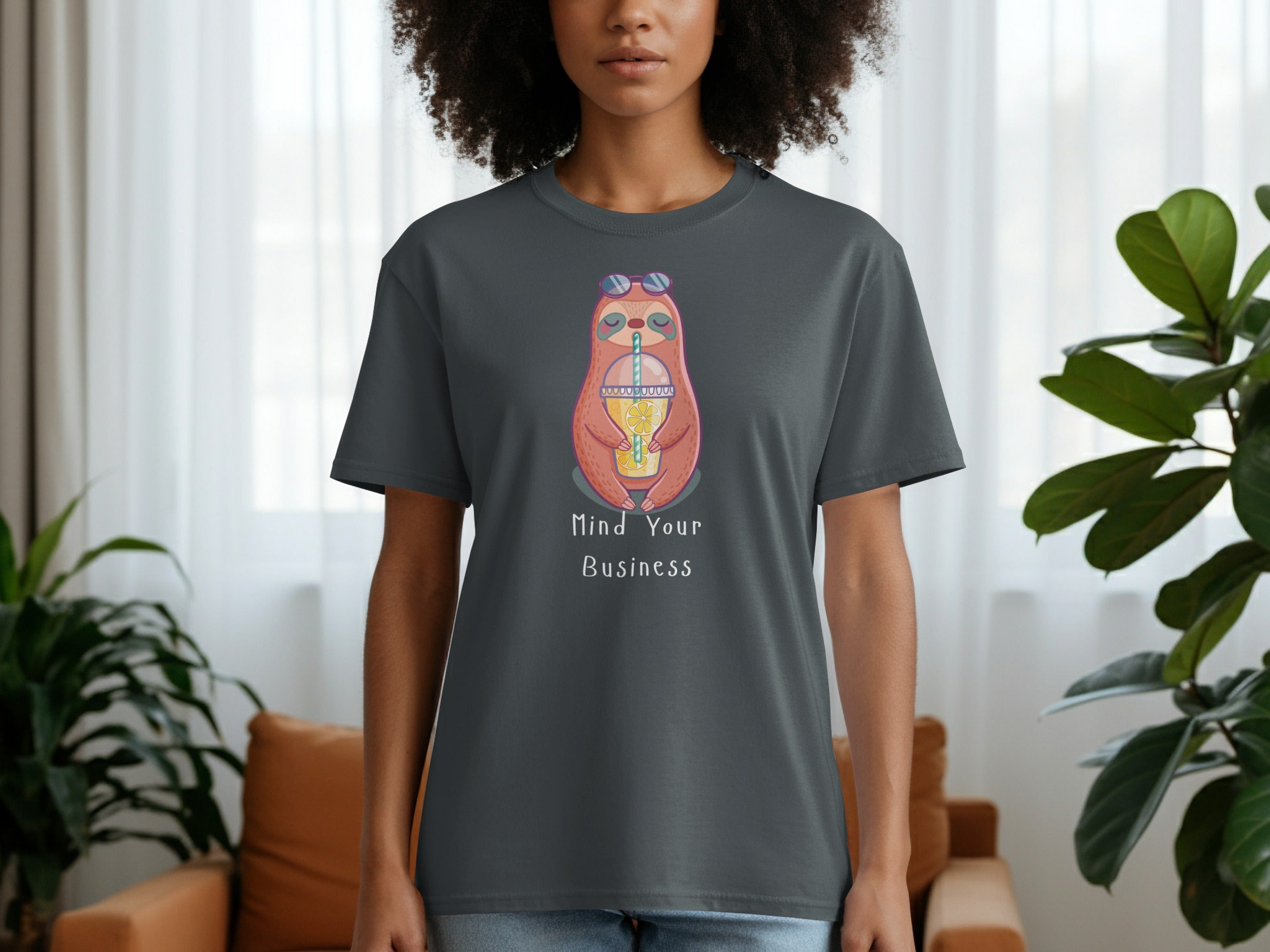 Gray t-shirt with a cartoon sloth wearing sunglasses holding a drink, reading "Mind Your Business."
