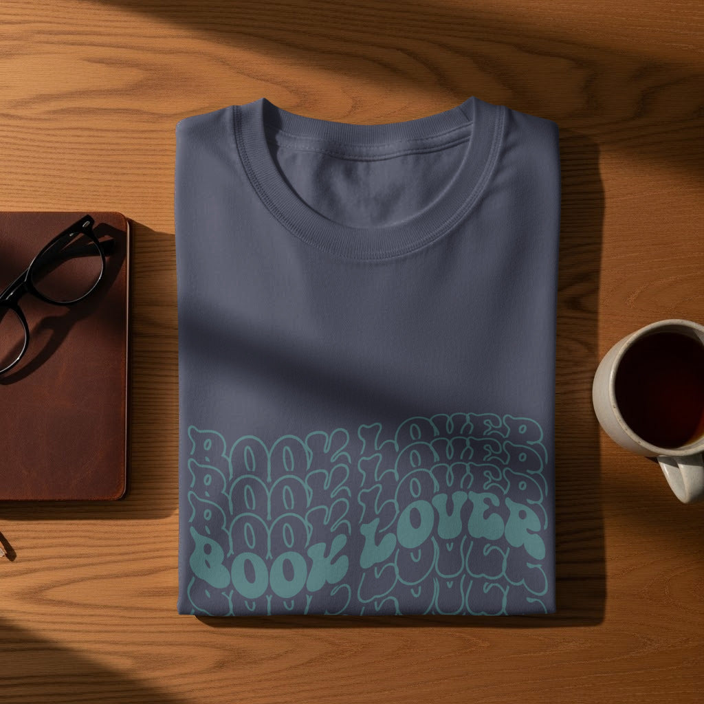 Dark blue t-shirt with "Book Lover" in a repeating, wavy teal font.
