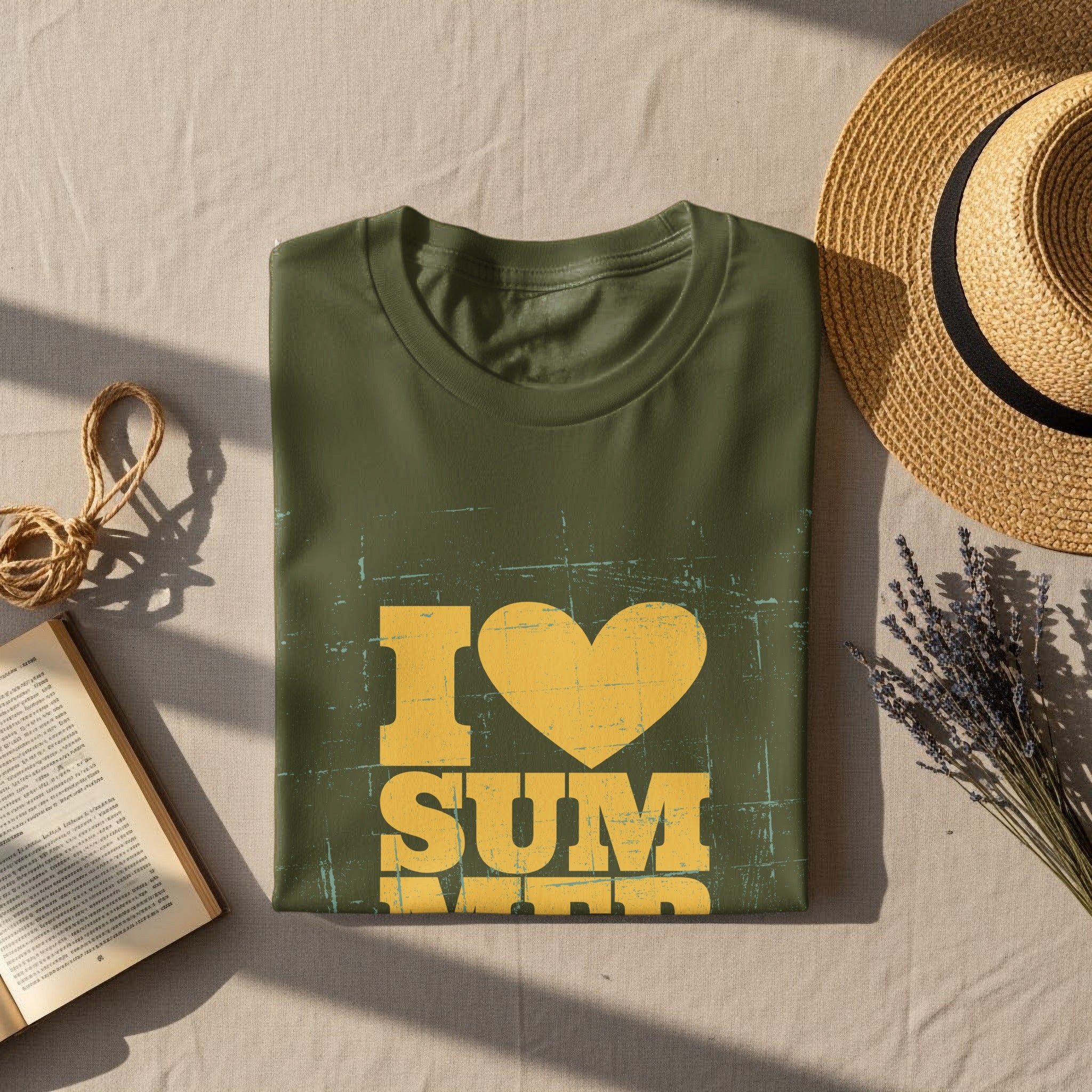 Green t-shirt with distressed "I ❤️ SUMMER" graphic, book, and straw hat.