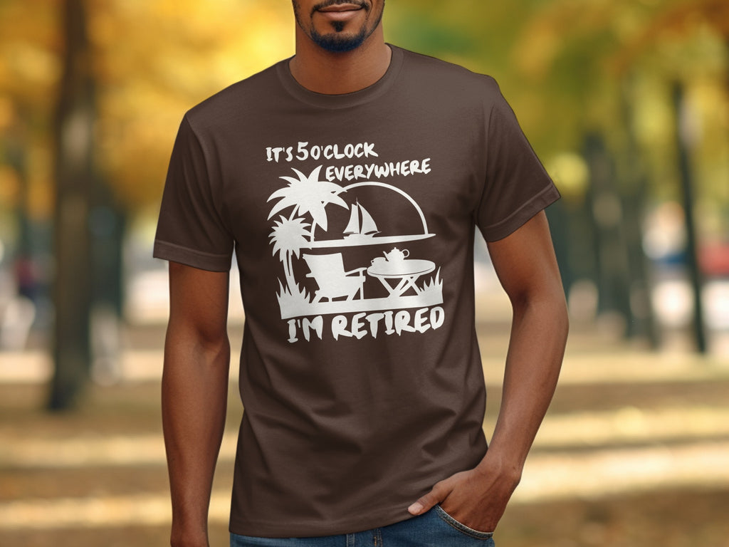 Brown t-shirt with white graphic saying "It's 5 O'Clock Everywhere I'm Retired."