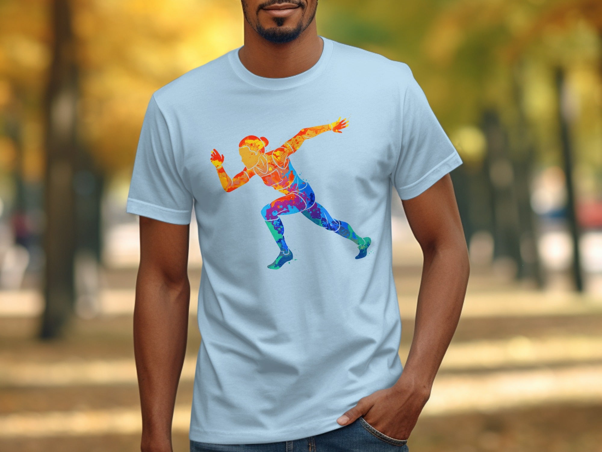 T-shirt with colorful runner graphic on light blue fabric outdoors.