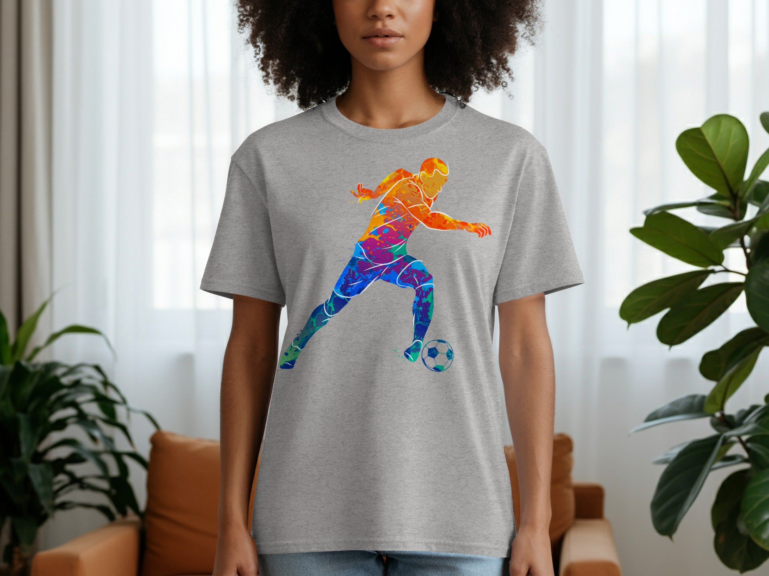 Grey t-shirt with a colorful watercolor soccer player and ball graphic.