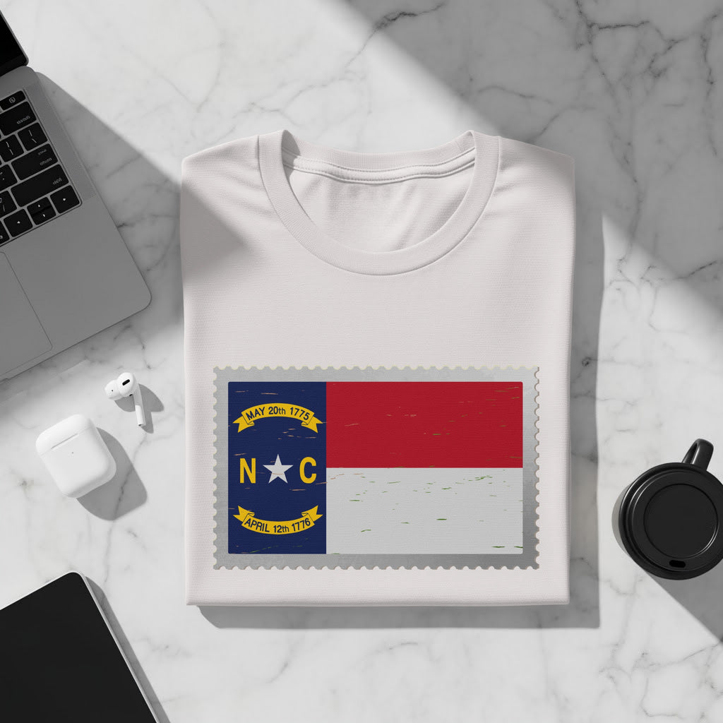 White t-shirt featuring a stamp design of the North Carolina flag.