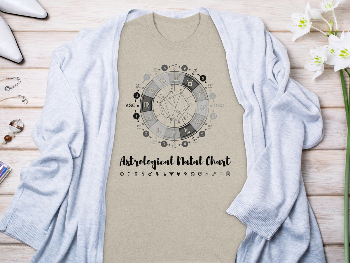 Light tan t-shirt with a black astrological natal chart graphic and text.