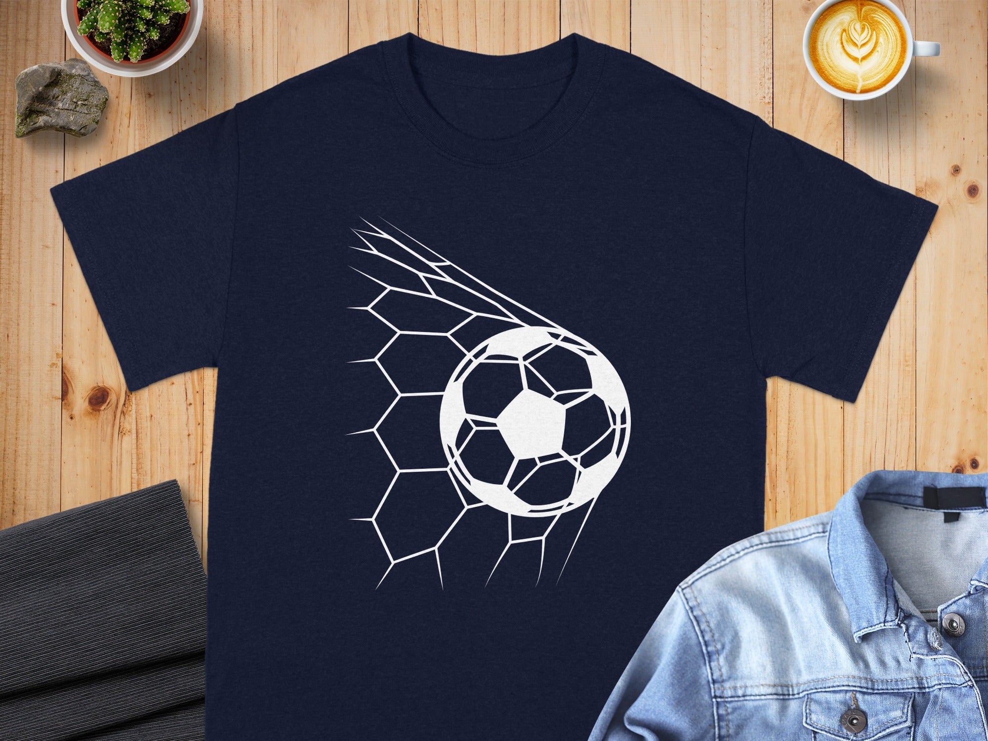 Navy t-shirt with white soccer ball going through a net graphic.