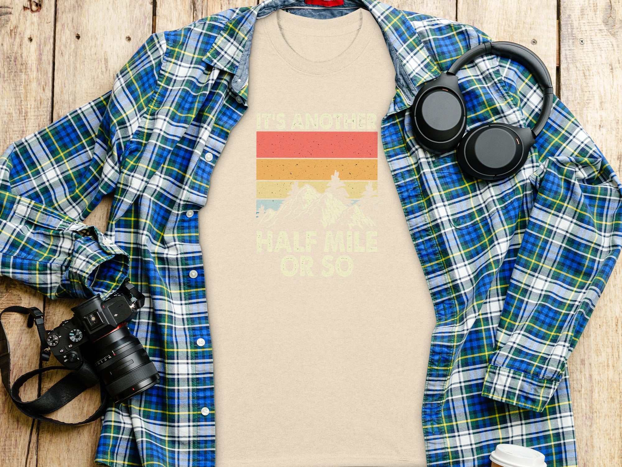 Beige t-shirt with vintage sunset graphic and text "It's another half mile or so".
