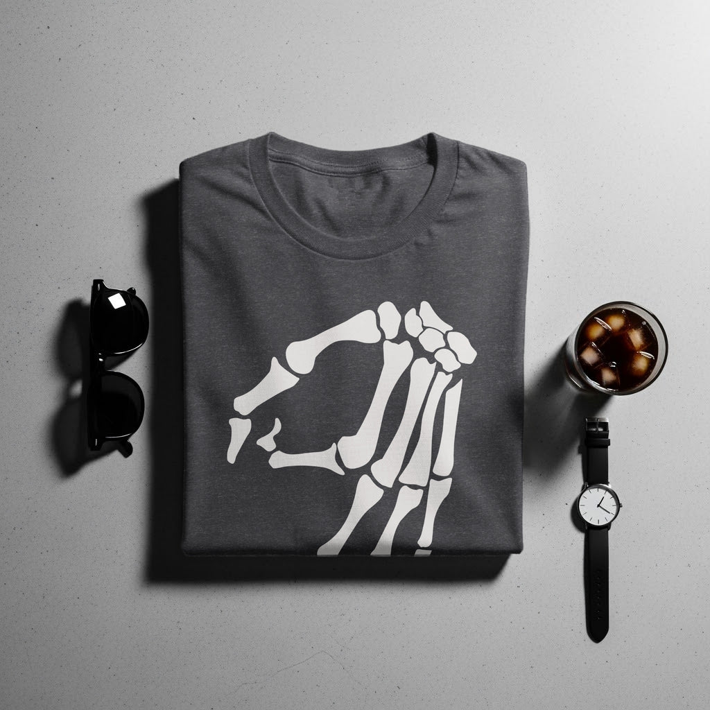 Dark grey t-shirt with a white skeleton hand graphic, displayed with sunglasses, watch and drink.