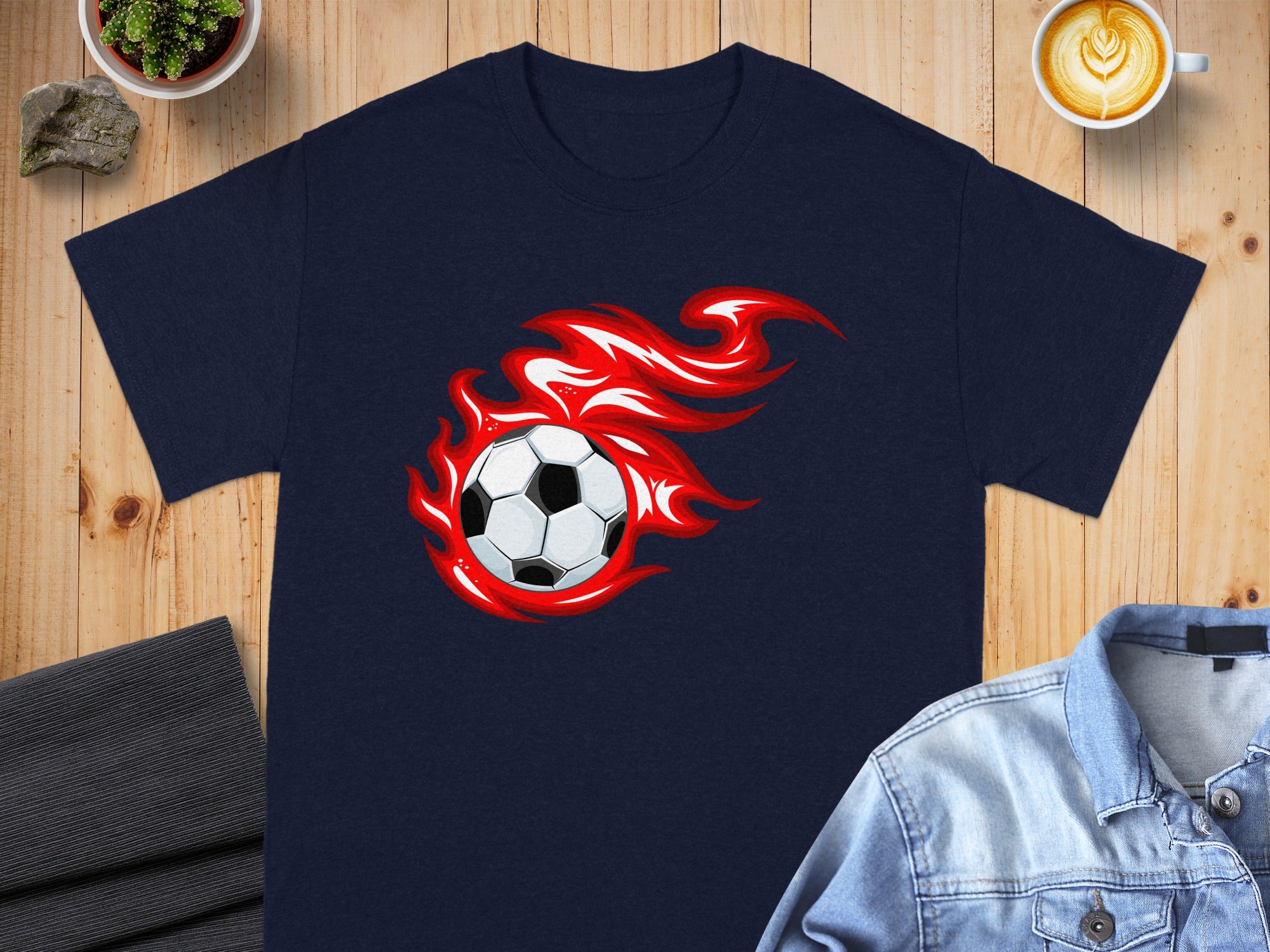 Navy t-shirt with a soccer ball engulfed in red flames graphic.