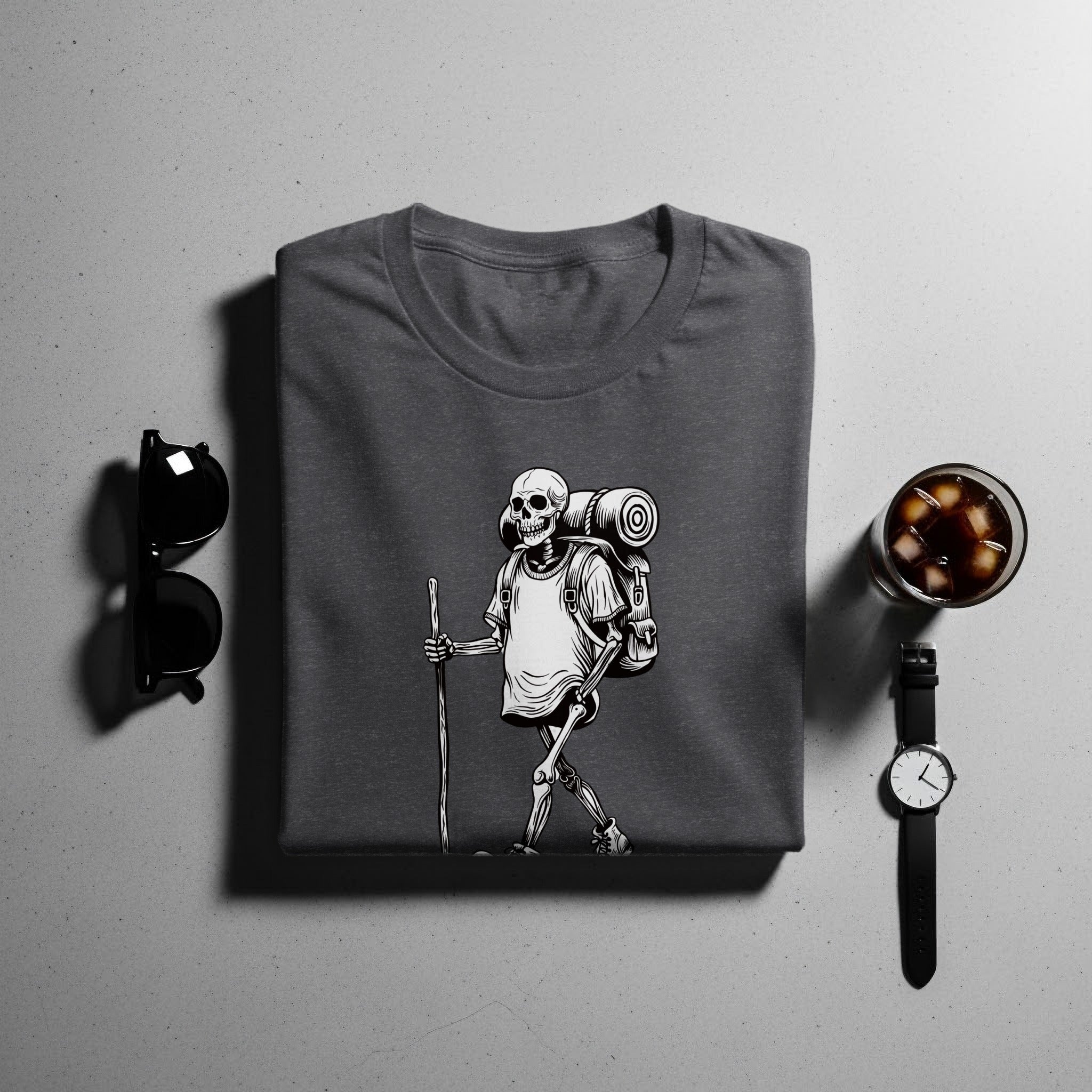 T-shirt with a skeleton design carrying a backpack and hiking stick.