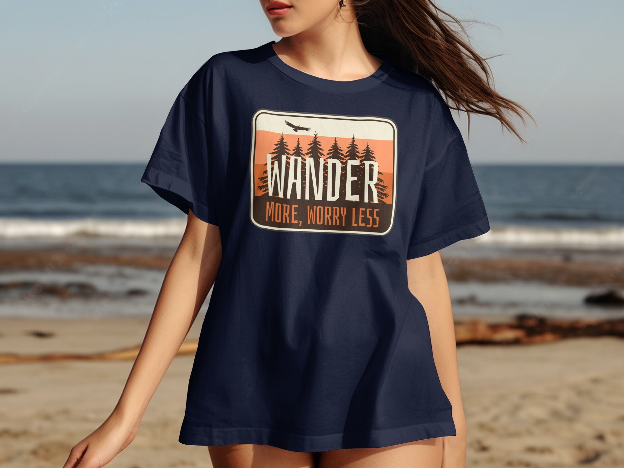Navy t-shirt with a landscape graphic and text: WANDER MORE, WORRY LESS.