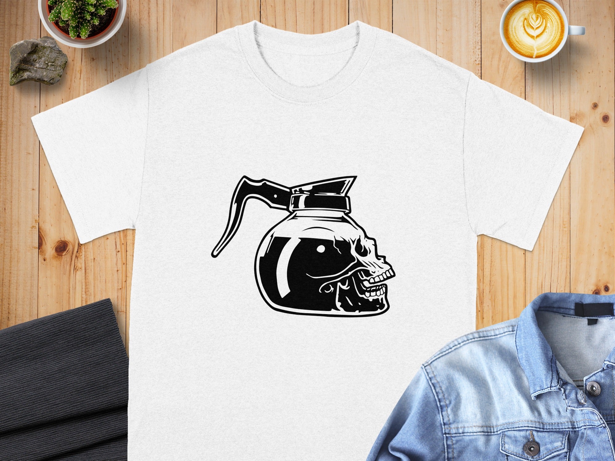 Black and white graphic of a coffee pot with a skull design on white t-shirt.