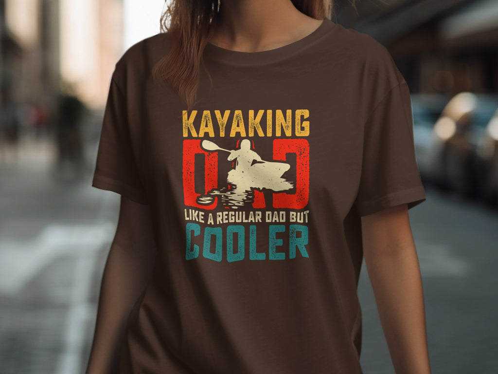 Kayaking Dad like a regular dad but cooler graphic t-shirt on brown.