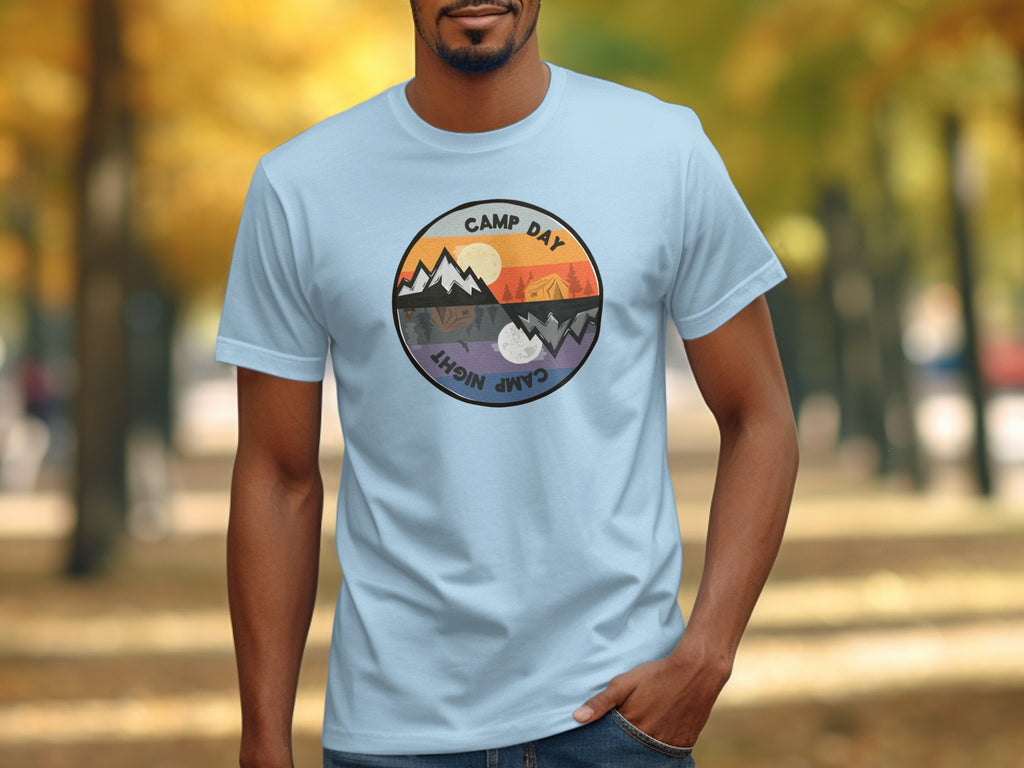 Light blue t-shirt with a circular graphic featuring "Camp Day" and "Camp Night" and mountain scenery.