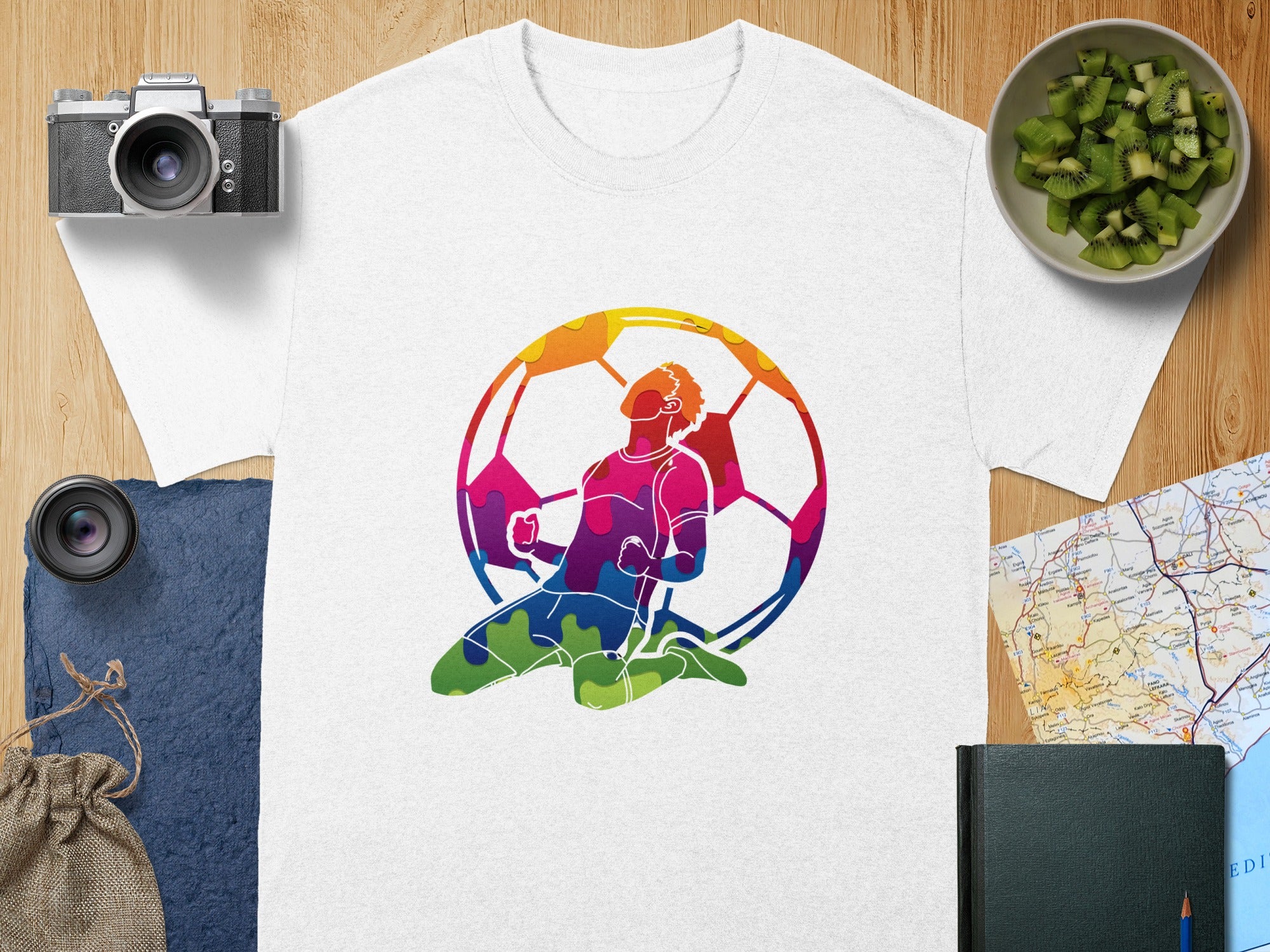 White t-shirt with colorful abstract soccer player graphic.