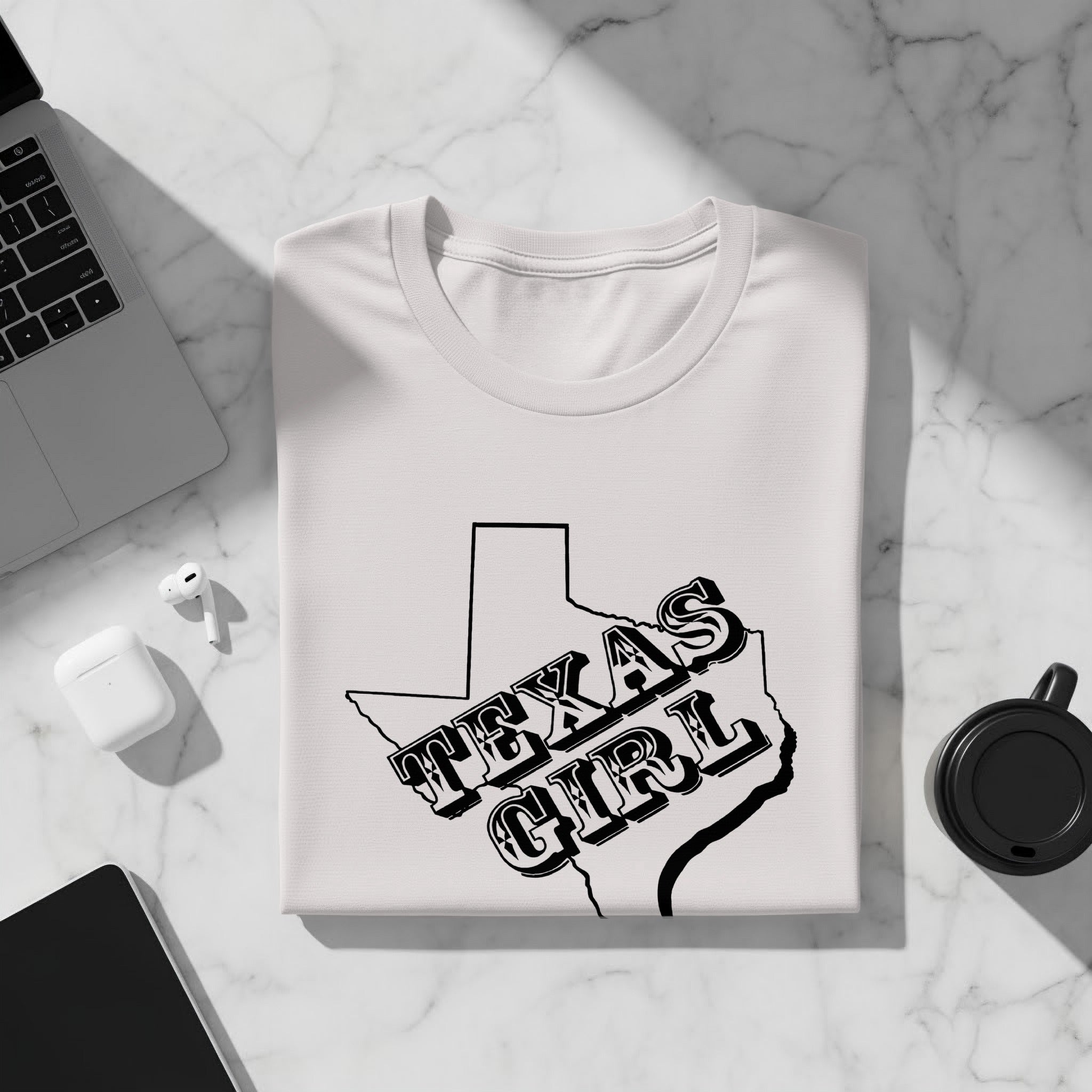 White t-shirt with outline of Texas and text "TEXAS GIRL" in black.